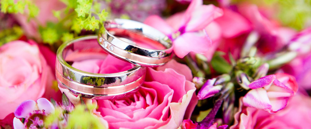 Two wedding rings in a bouquet of flowers.